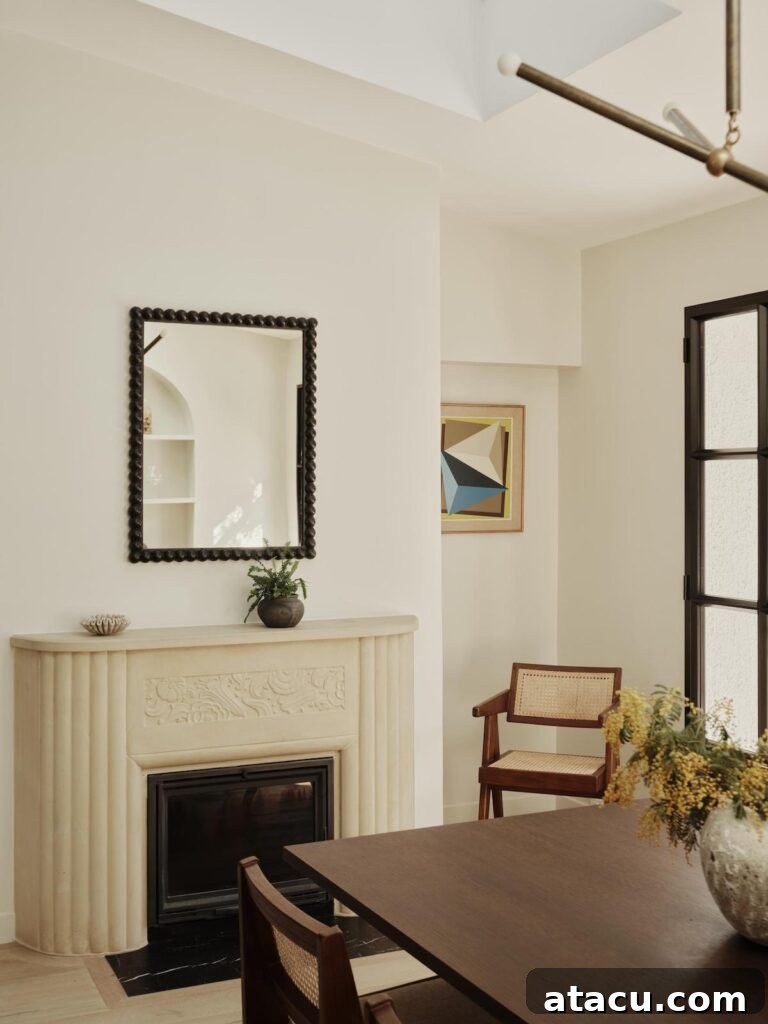 Textured fireplace featuring a fluted stone surround, crowned by a prominent black beaded mirror, creating a striking focal point.