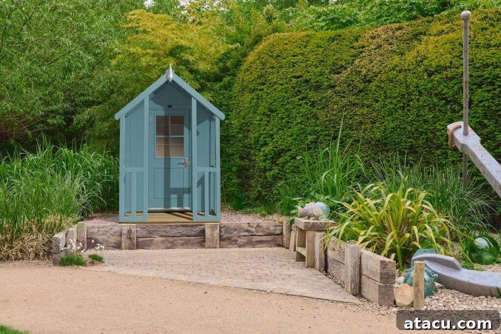 A blue garden shed in a lush green landscaped garden.