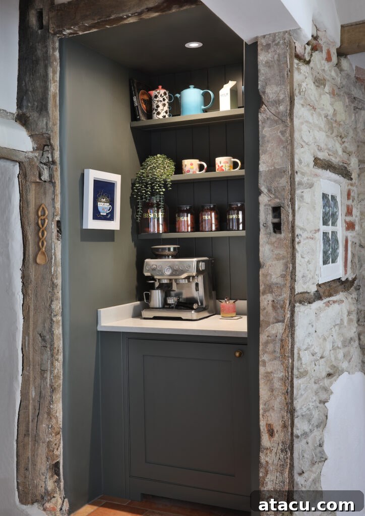 Charming rustic coffee station set within a reclaimed stone alcove, featuring dark cabinetry, vintage mugs, and a modern espresso machine.