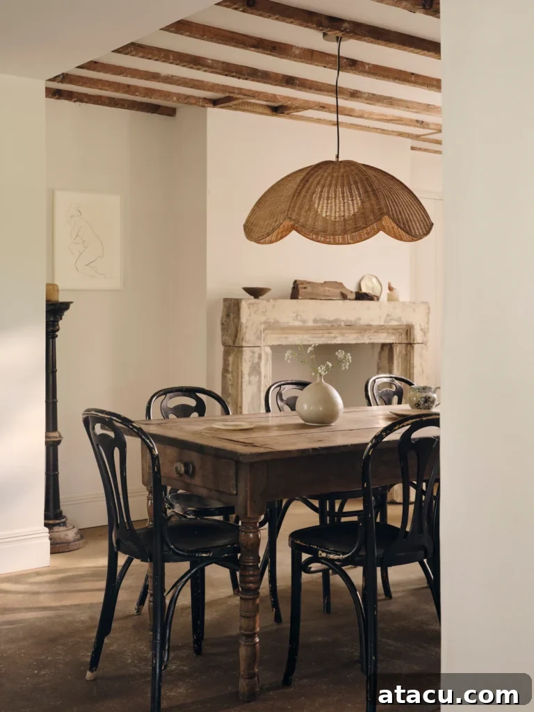 Rattan pendant light casting warm light in a sunlit dining room, highlighting its sculptural design.