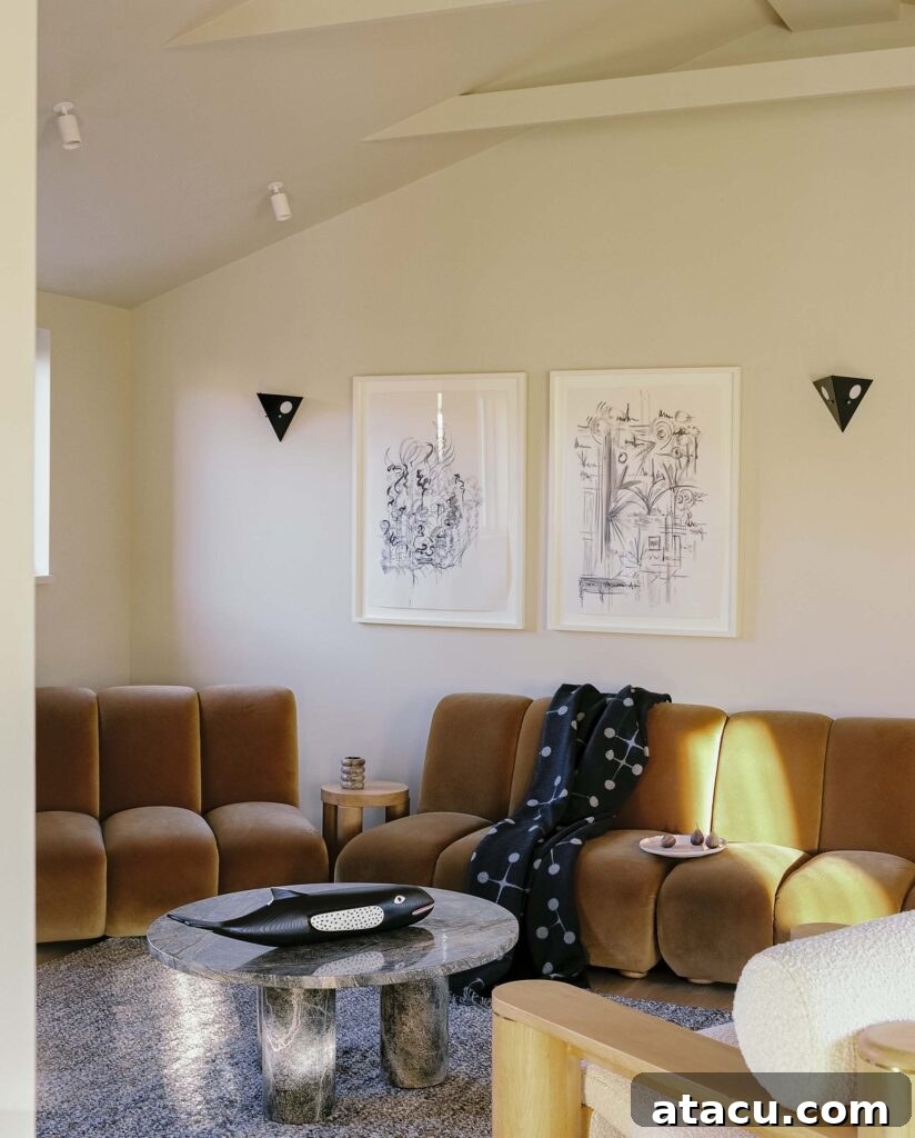 Modern living room with caramel velvet seating and abstract art.