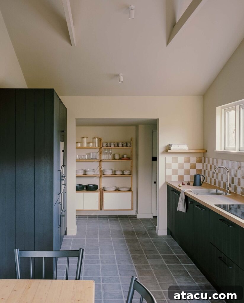 Minimalist kitchen with open shelving and tiled backsplash.