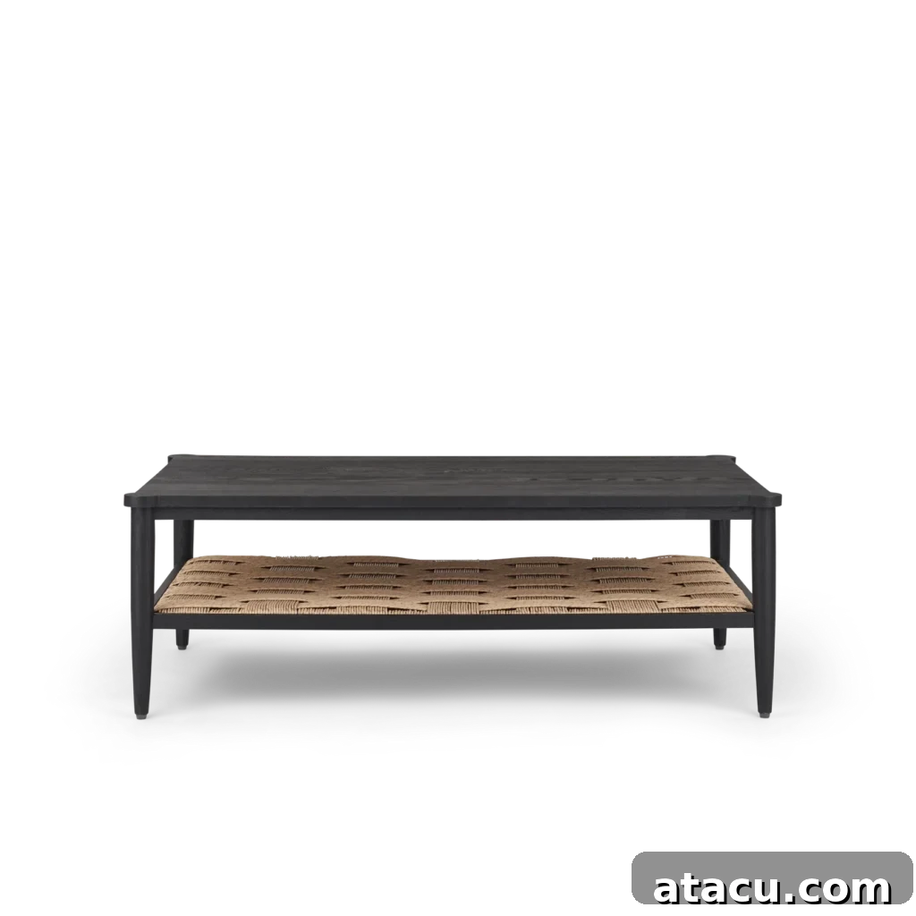An elegant oak and rattan coffee table, providing a perfect base for a thoughtfully crafted vignette in a modern living room.