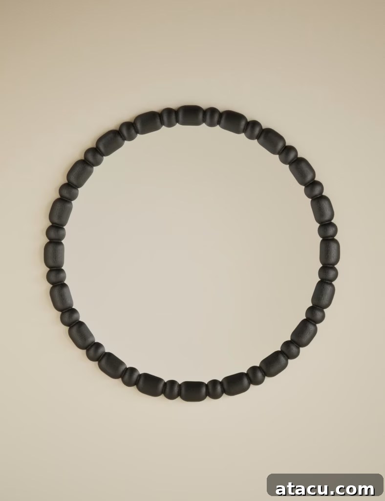Close-up of a stylish round bobbin mirror frame, highlighting its craftsmanship and texture.