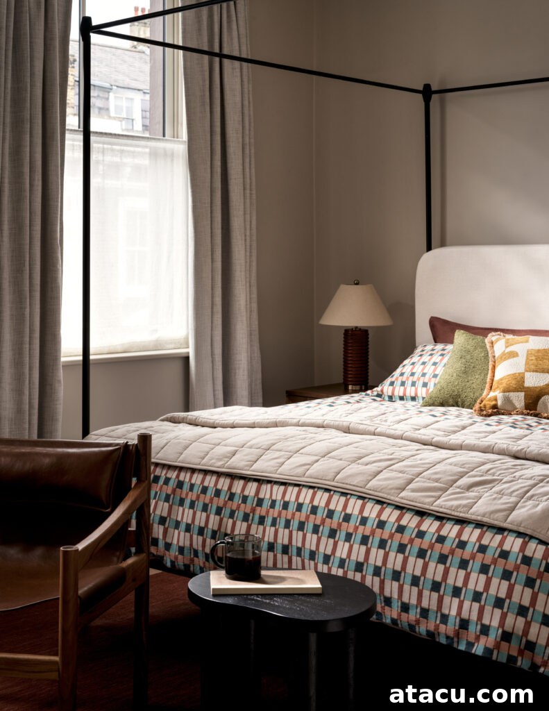 Canopy bed with geometric bedding and warm wood furniture in a bright bedroom.