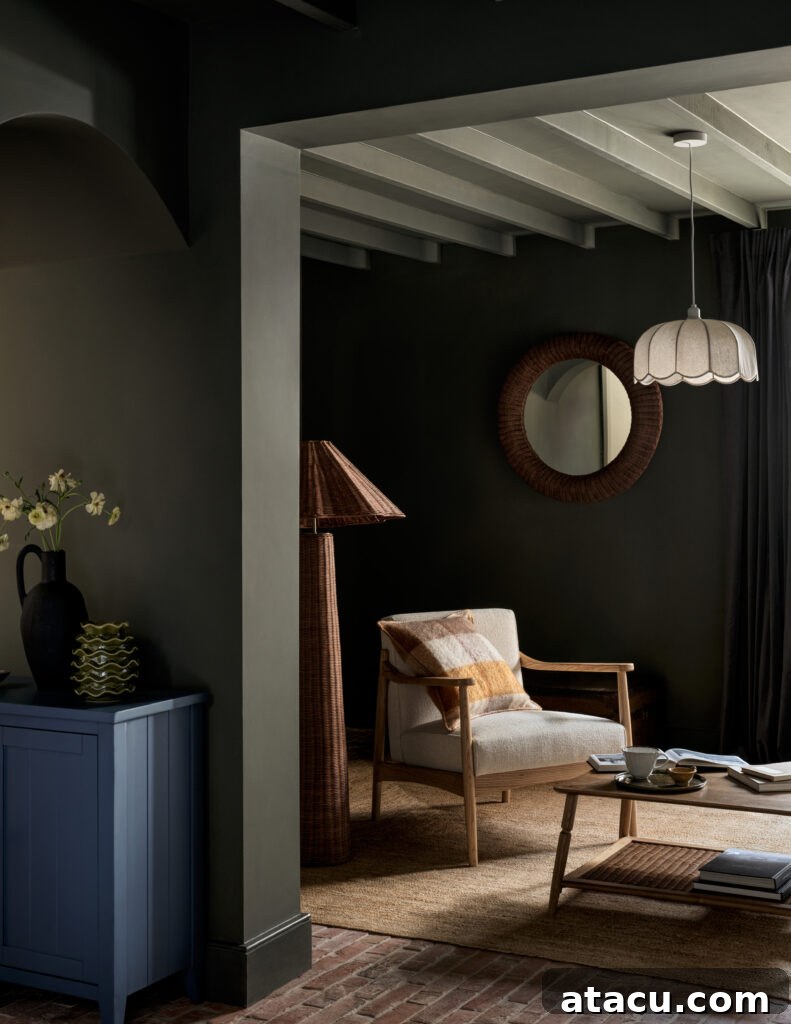 Dark-toned lounge with wooden armchair, scalloped pendant, and rattan textures.