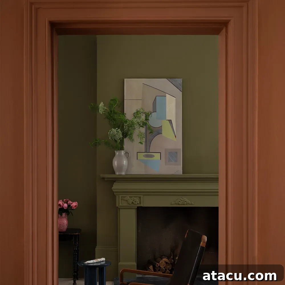 Moody interior with Farrow & Ball Marmelo doorframe and Dibber walls, featuring a green fireplace and abstract artwork.