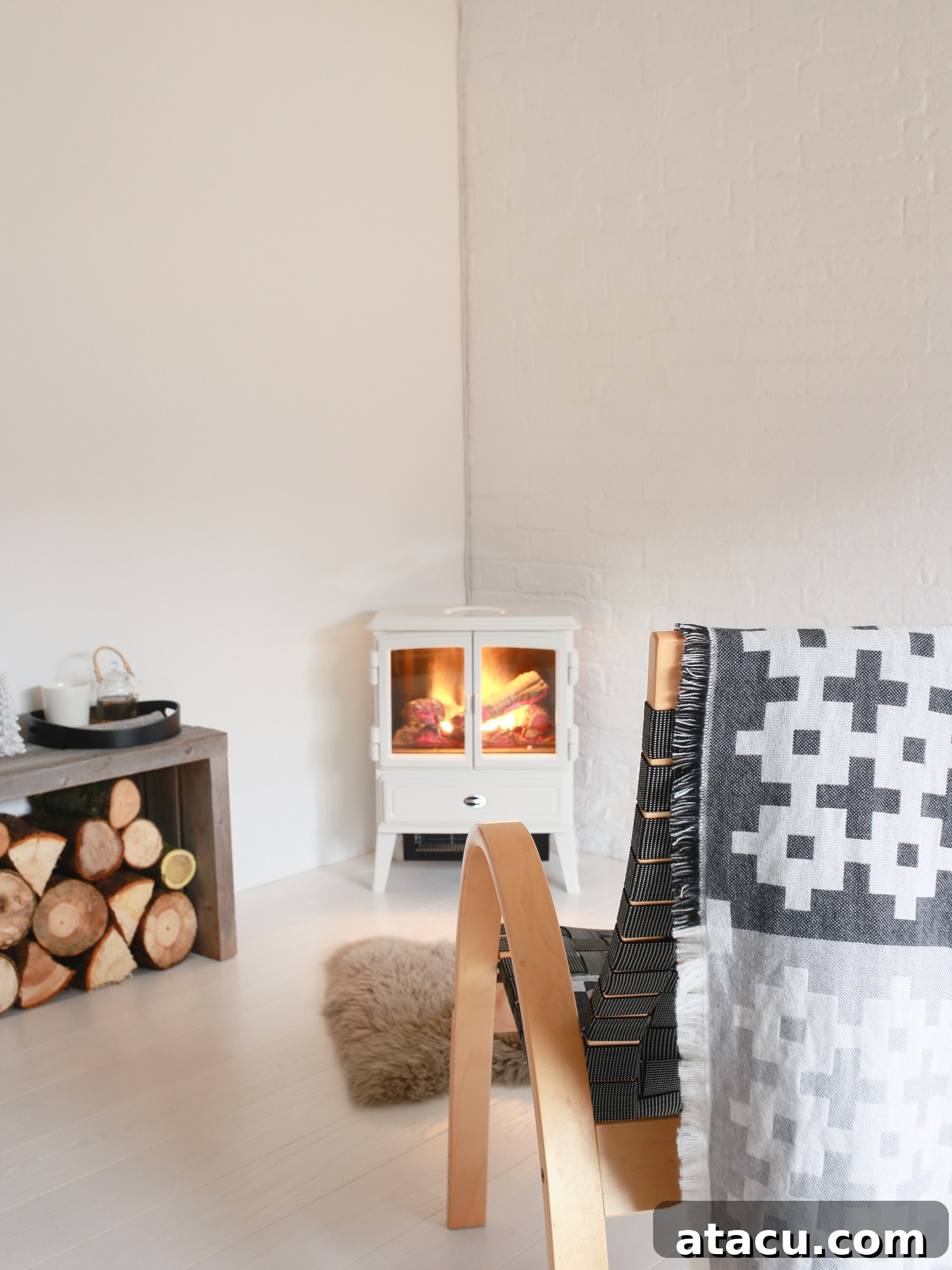 Dimplex electric log burner Opti-myst stove by Design Hunter in a modern studio setting, creating a cozy corner