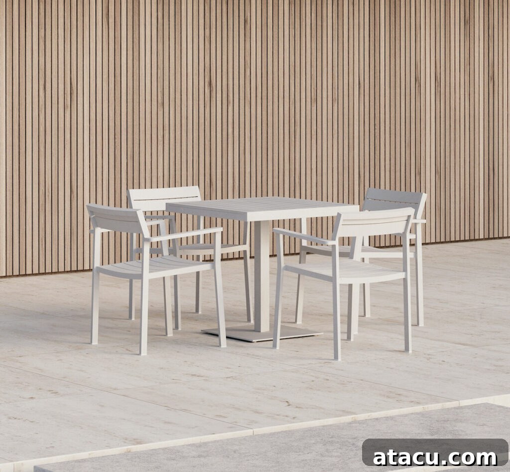 Upgrade Your Outdoors: 10 Best Dining Sets for 2024 8 A pristine white outdoor dining table paired with four chairs, featuring a contemporary design for stylish gatherings.
