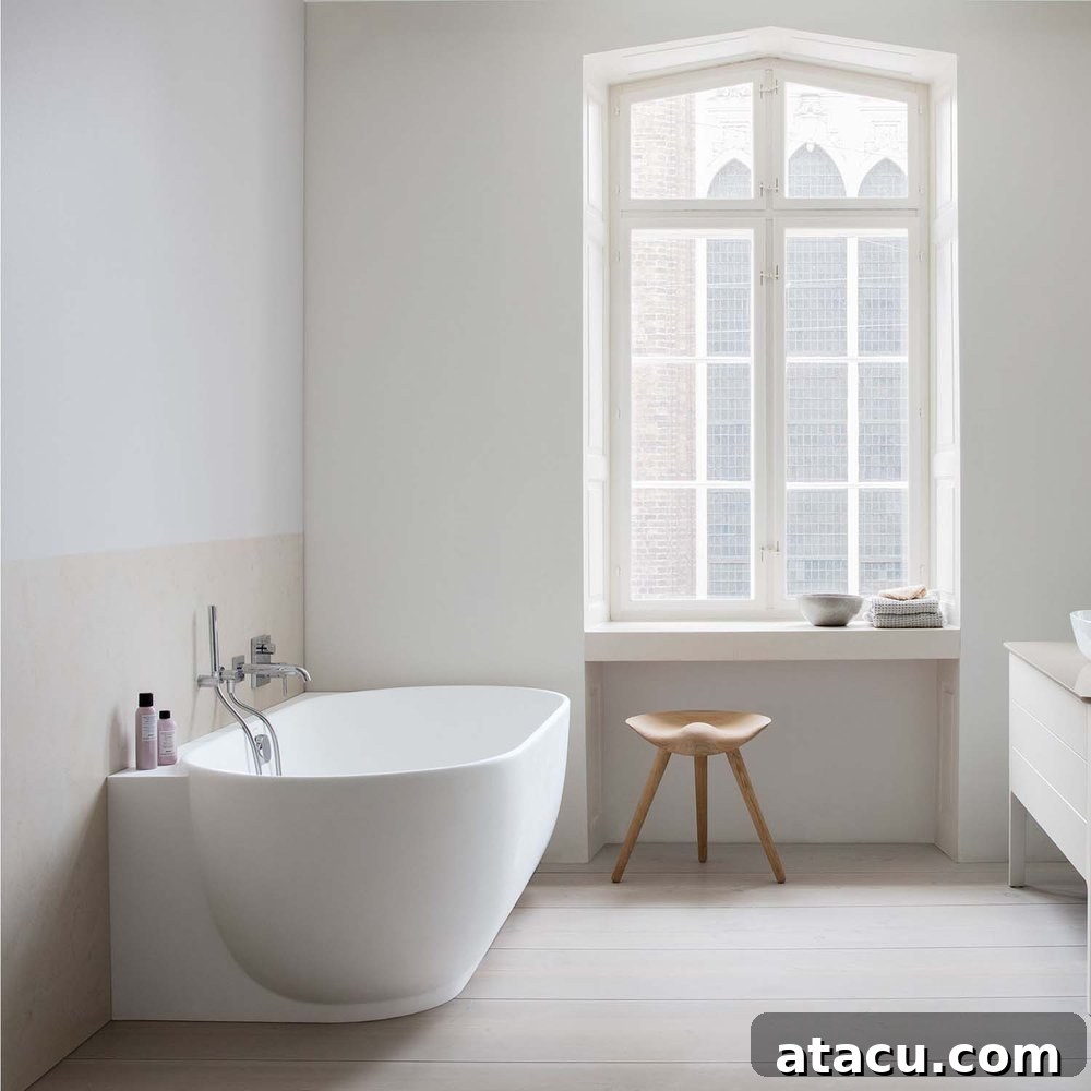 A modern freestanding back to wall bath in a minimalist bathroom